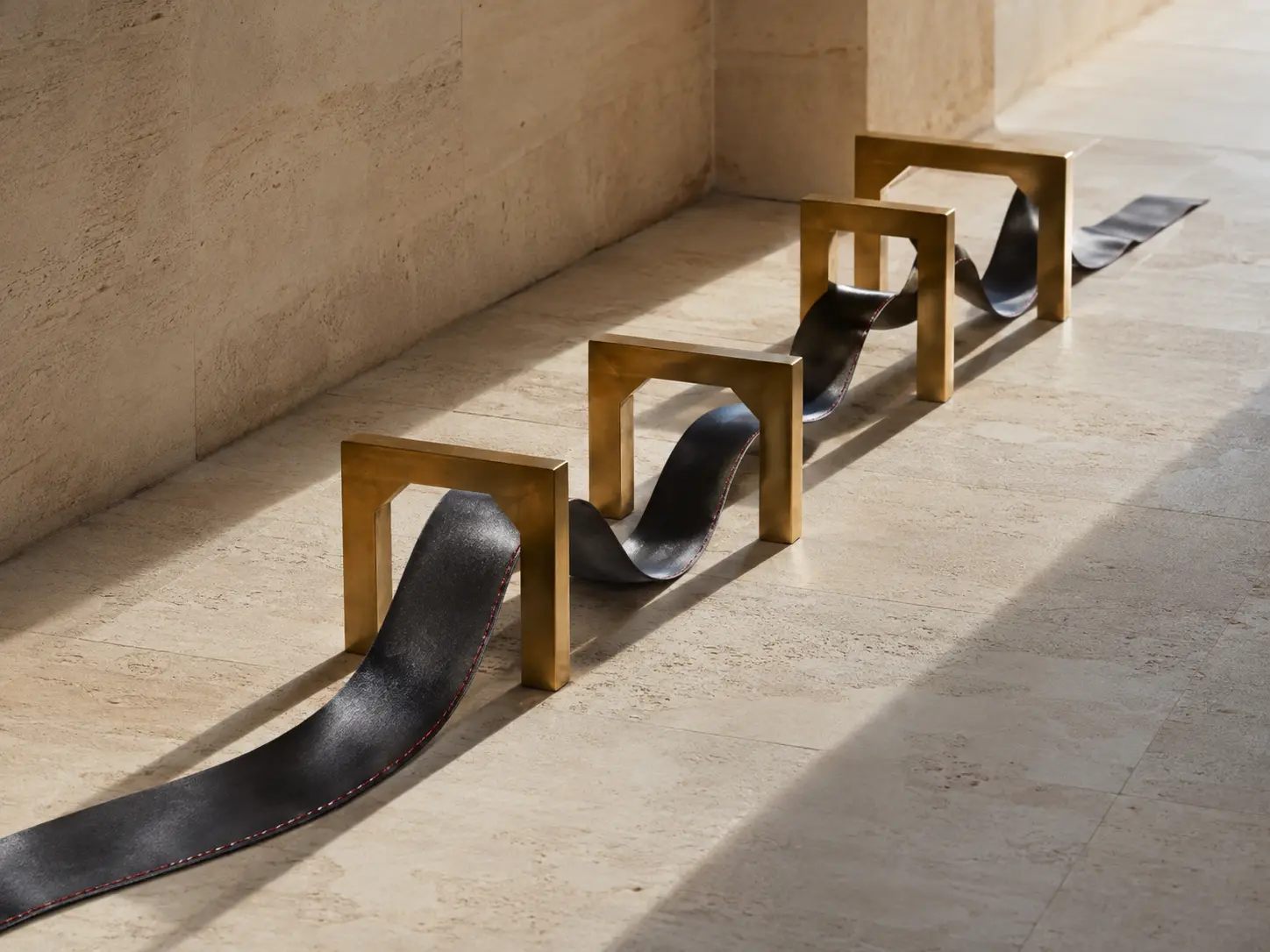 Charcoal ribbon passing through brass gates across a sunlit stone corridor
